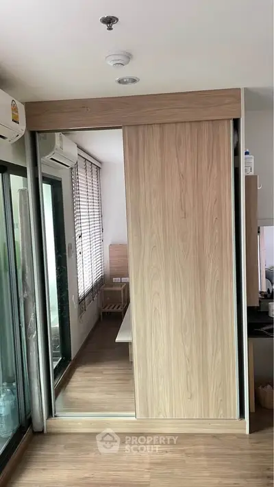 Modern interior with sliding wooden doors and air conditioning, showcasing sleek design and functionality.