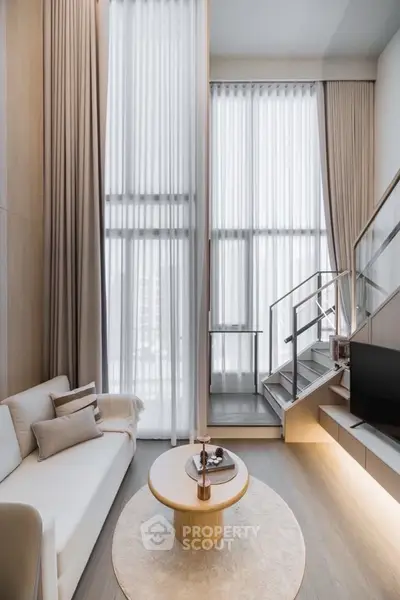 Luxurious modern living room with high ceilings and elegant decor