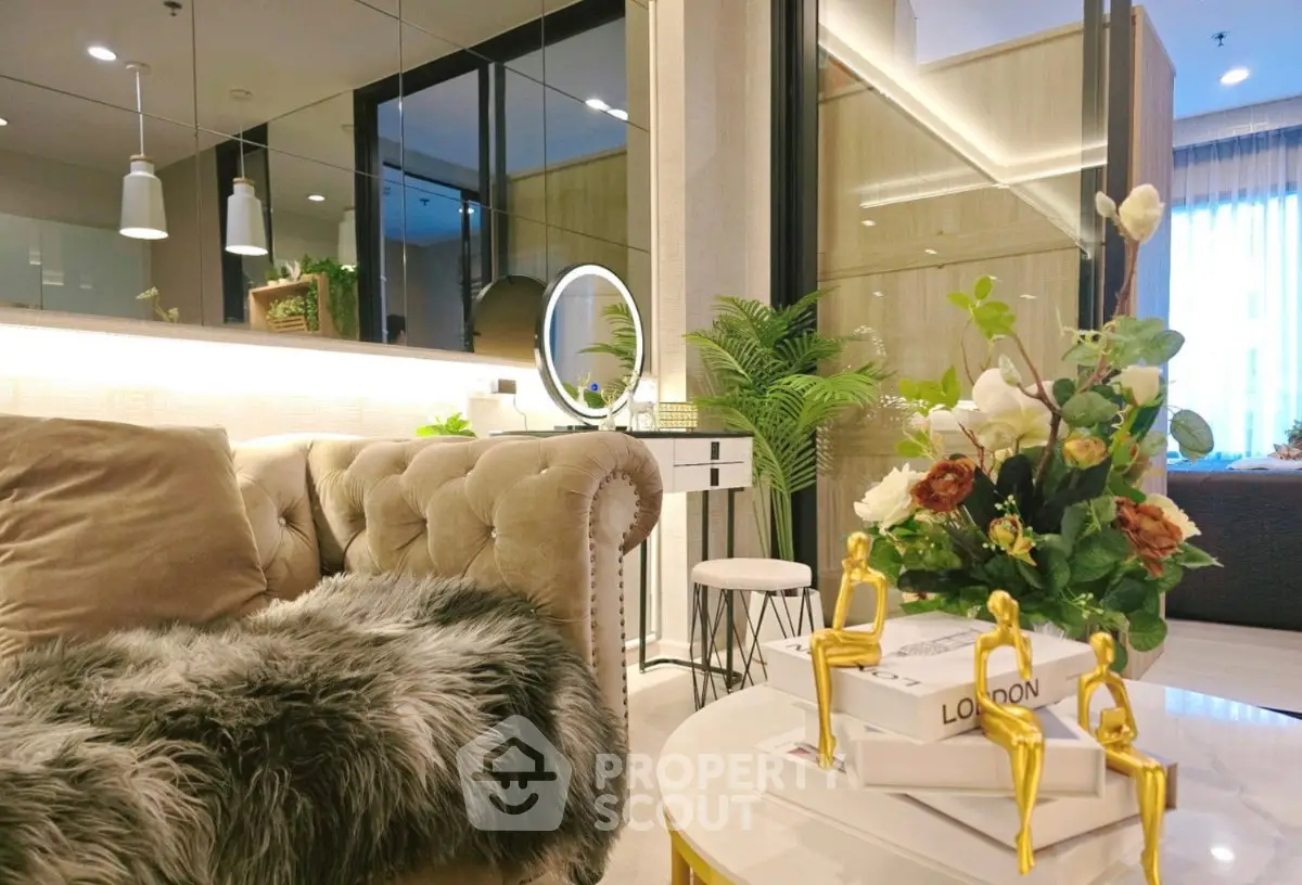 Luxurious living room with plush sofa, elegant decor, and modern lighting in a stylish apartment.