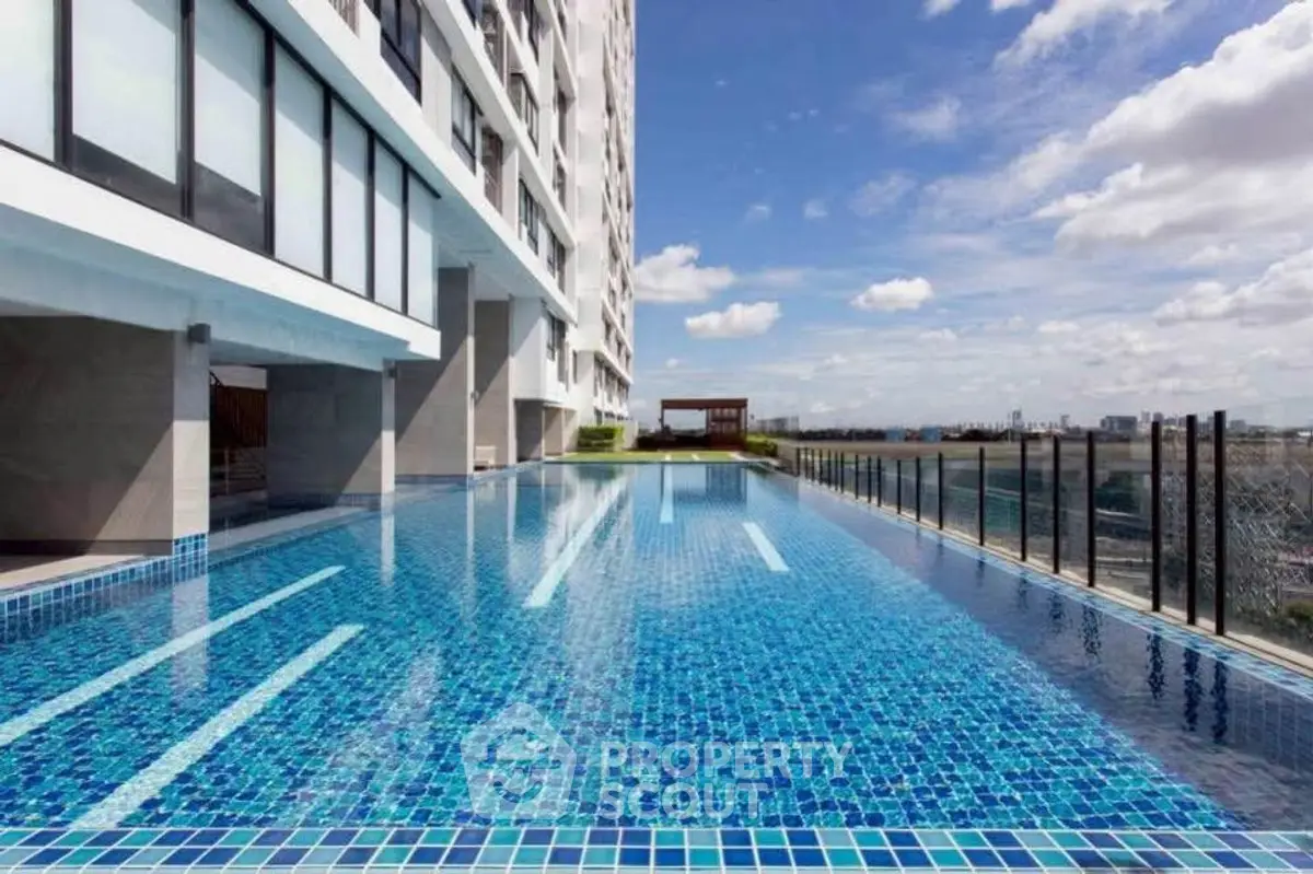 Luxurious high-rise building with stunning rooftop pool and panoramic city views.