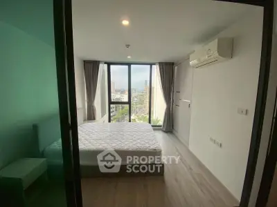 Modern bedroom with large windows and city view, featuring minimalist design and air conditioning.