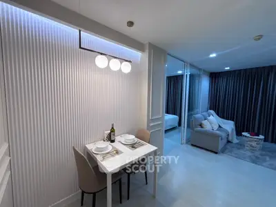 Modern open-plan living and dining area with stylish decor and ambient lighting