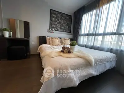 Luxurious bedroom with large windows and elegant decor in modern apartment.