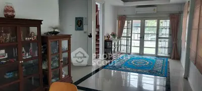 Spacious living room with elegant decor and large windows offering natural light.