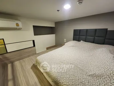 Modern bedroom with stylish decor and cozy ambiance in a contemporary apartment.
