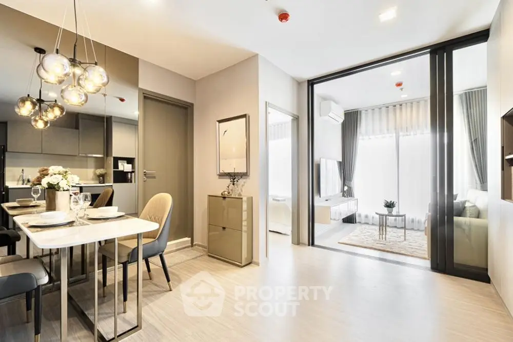 Modern open-plan living and dining area with stylish lighting and elegant decor