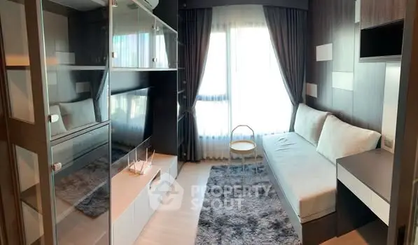 Modern living room with sleek furniture and large window, perfect for urban living.