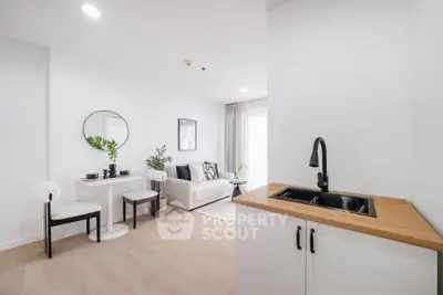 Modern open-plan living room with sleek kitchenette and stylish decor