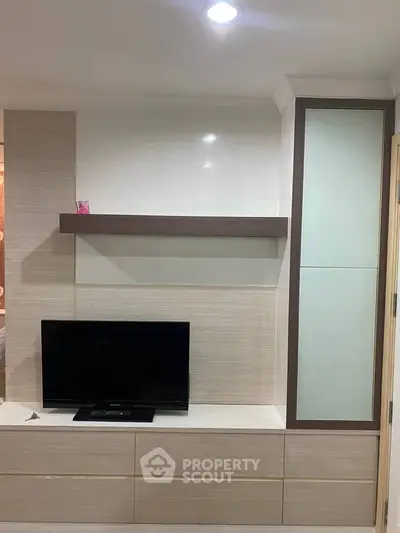 Modern living room with sleek TV unit and stylish shelving