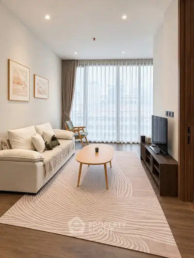 Modern living room with elegant decor, large window, and cozy seating area in a stylish apartment.