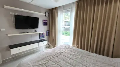 Cozy bedroom with modern decor, wall-mounted TV, and large window with garden view.