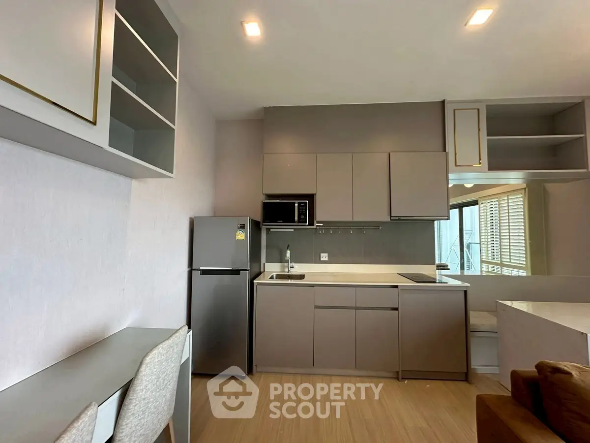 Modern kitchen with sleek cabinetry and built-in appliances in a stylish apartment.
