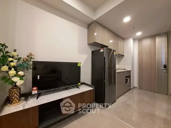Modern kitchen with sleek cabinets and stainless steel appliances in a stylish apartment.