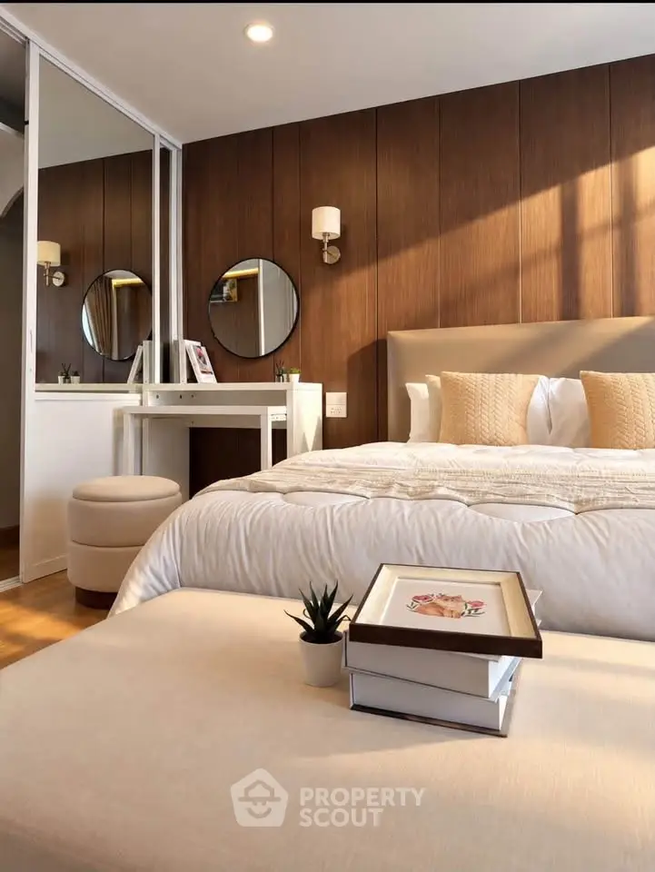 Luxurious bedroom with elegant decor and cozy ambiance, featuring a stylish vanity and plush bedding.