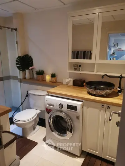 Charming bathroom with washing machine and stylish decor
