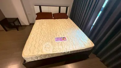 Modern bedroom with stylish bed and dark curtains, perfect for cozy living.