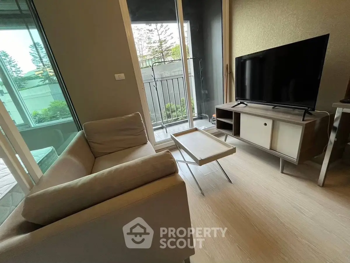 Modern living room with sleek furniture and balcony view, perfect for urban living.