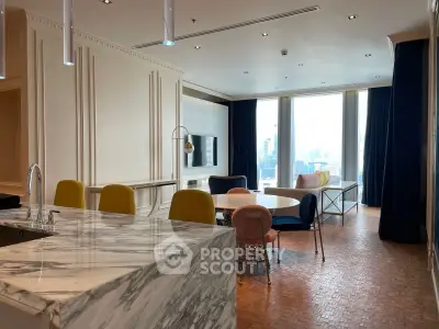 Luxurious open-plan living room with marble kitchen island and city view.