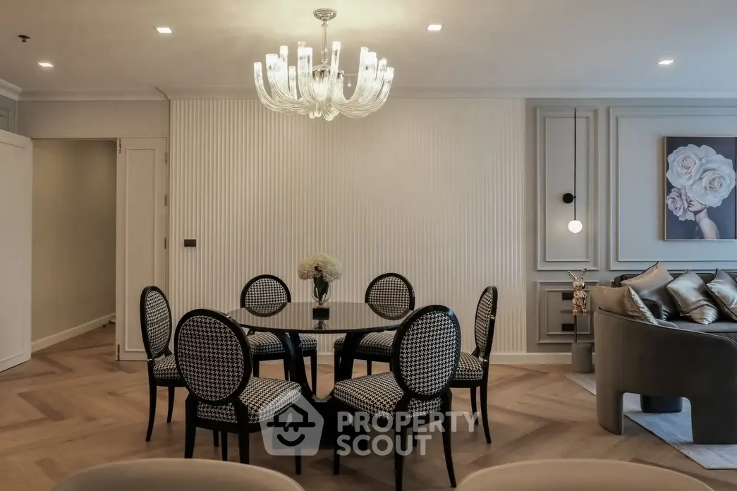 Elegant living room with chic dining area and modern chandelier