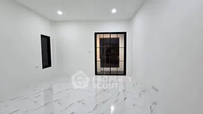 Spacious modern room with elegant marble flooring and large window, perfect for stylish living.