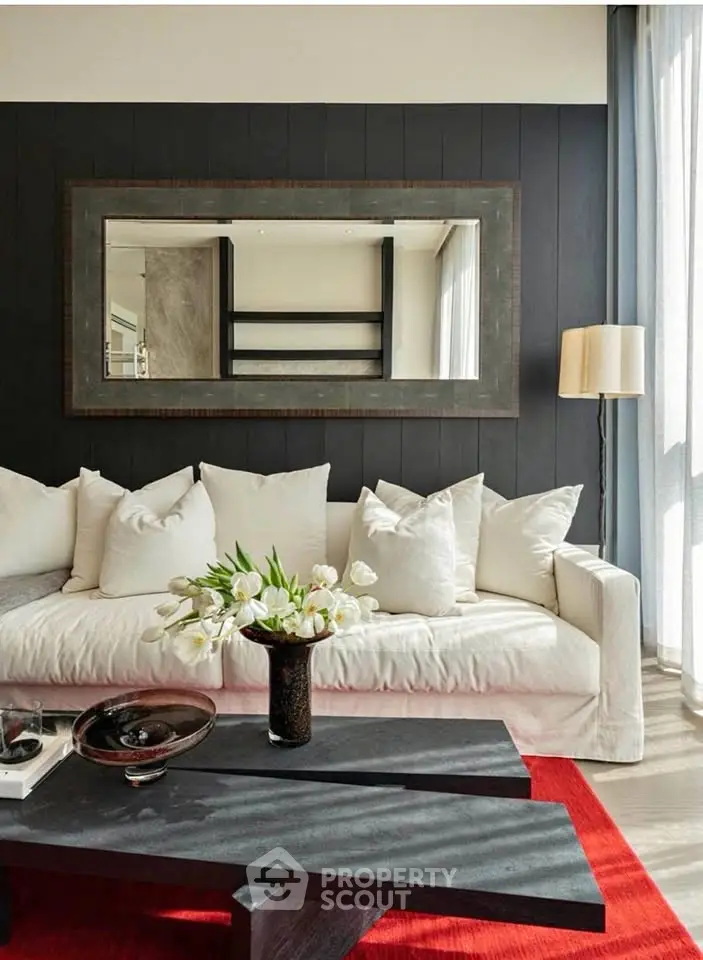 Stylish living room with modern decor, plush sofa, and elegant mirror accent.