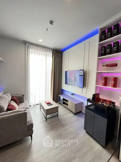 Modern living room with stylish decor and ambient lighting, featuring a cozy sofa and wall-mounted TV.