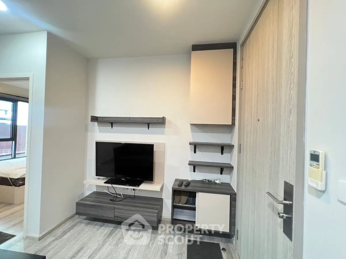 Modern living room with sleek TV unit and stylish decor in a contemporary apartment.