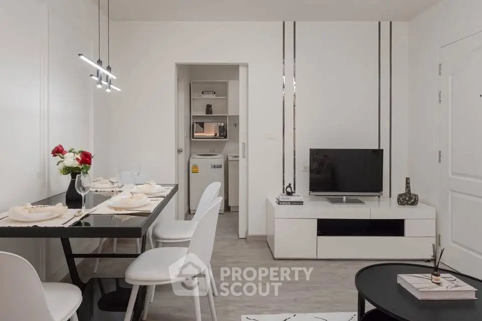 Modern living room with dining area and sleek decor in a stylish apartment.