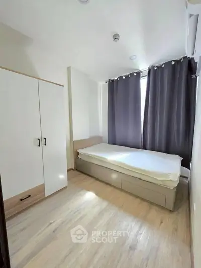 Cozy minimalist bedroom with natural light and modern furnishings