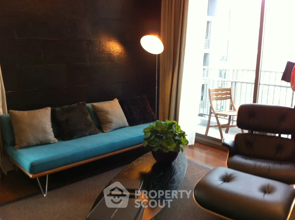 Stylish living room with modern furniture and balcony access, perfect for urban living.