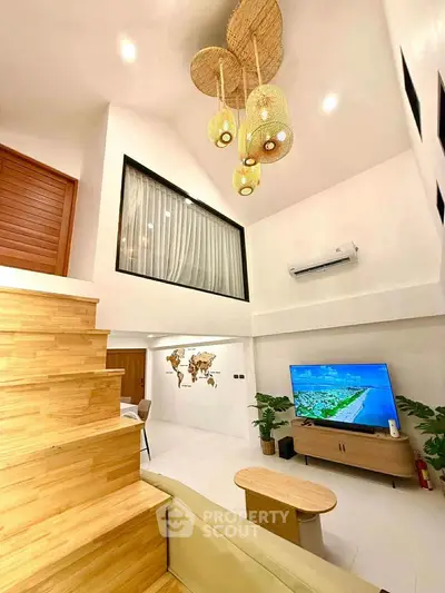 Modern living room with high ceiling, stylish lighting, and wooden staircase