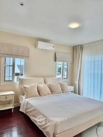 Spacious bedroom with elegant decor and natural light in modern home
