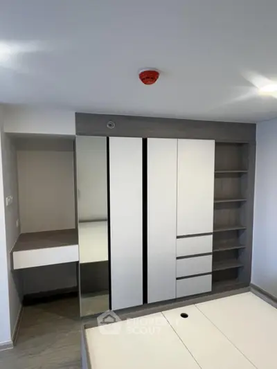 Modern bedroom with sleek built-in wardrobe and minimalist design
