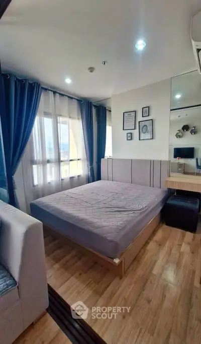 Modern bedroom with large window and stylish decor in a cozy apartment