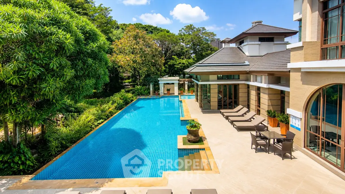 Luxurious villa with stunning pool and lush garden, perfect for relaxation and entertaining.