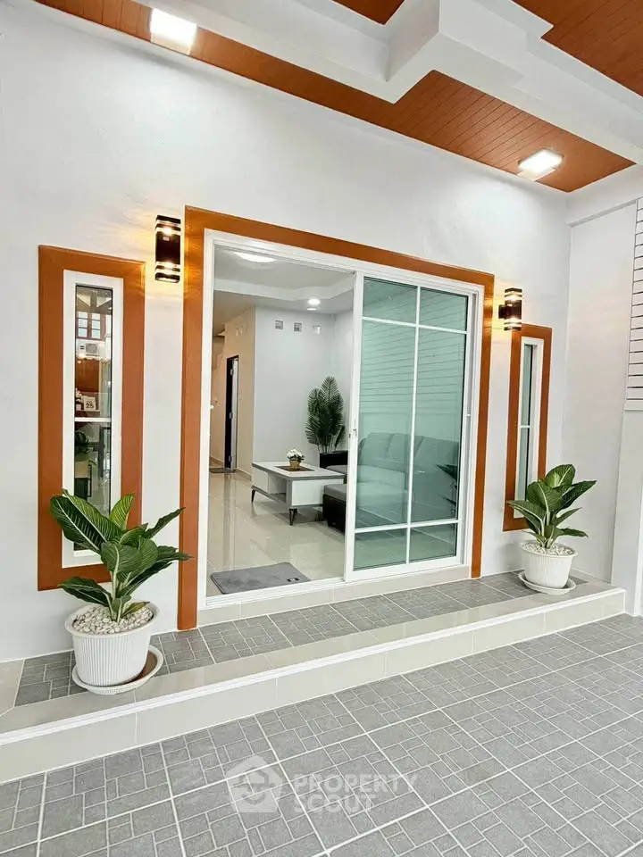 Modern home entrance with sliding glass doors and stylish lighting