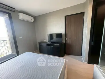 Modern bedroom with balcony view, featuring sleek furniture and air conditioning for ultimate comfort.