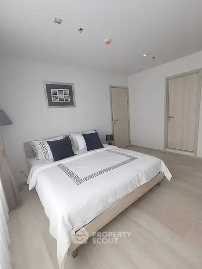 Modern bedroom with stylish decor and cozy ambiance in a contemporary apartment.