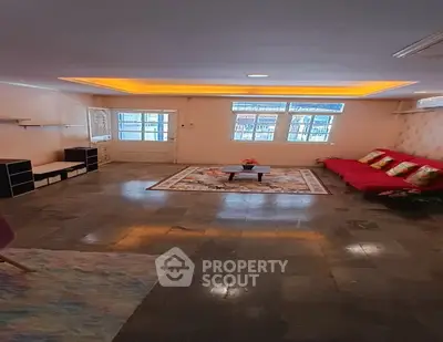 Spacious living room with modern lighting and cozy seating area.