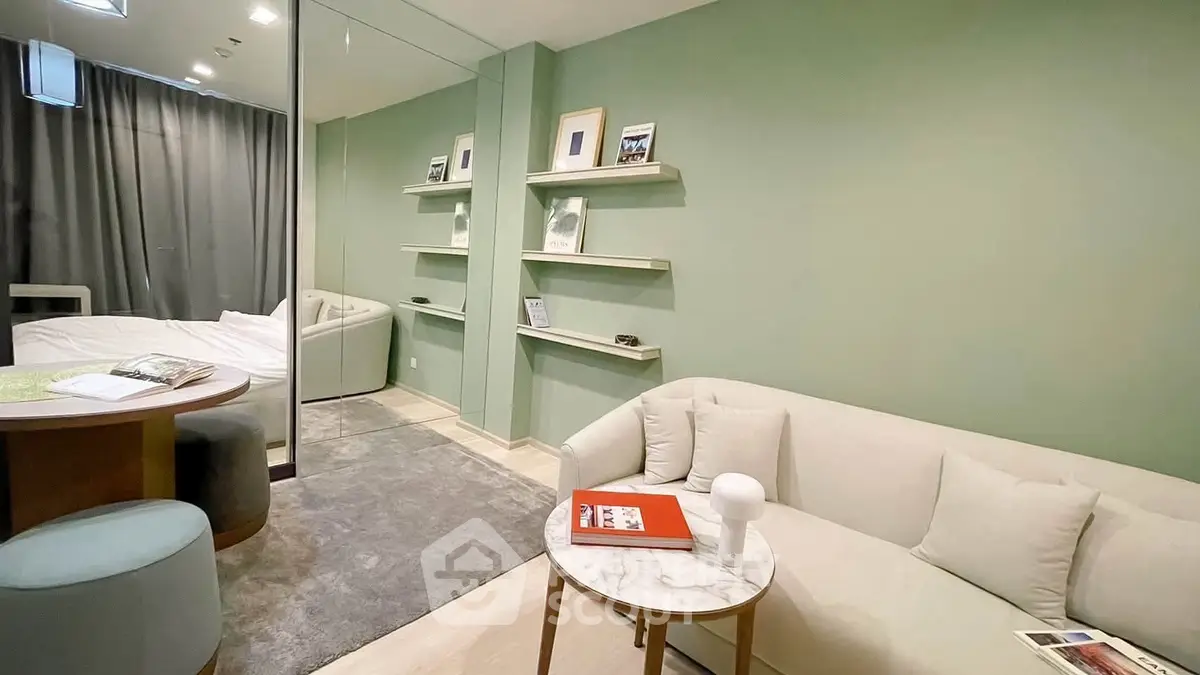 Chic modern living room with cozy sofa and stylish decor in a serene green setting.