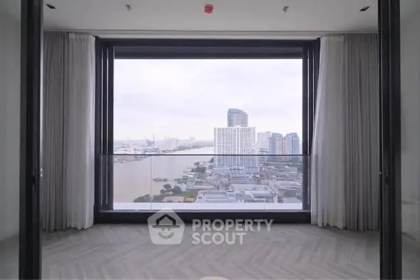 Stunning high-rise apartment with floor-to-ceiling windows offering breathtaking city and river views.