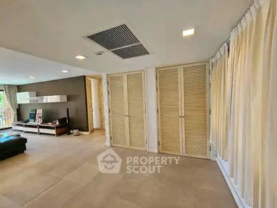 Spacious living room with modern decor and ample natural light