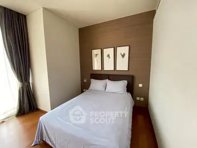 Cozy bedroom with elegant decor and natural light, perfect for relaxation and comfort.