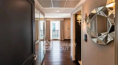 Luxurious apartment entrance with elegant decor and spacious living area.