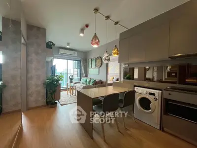 Modern open-plan living room and kitchen with stylish decor and natural light