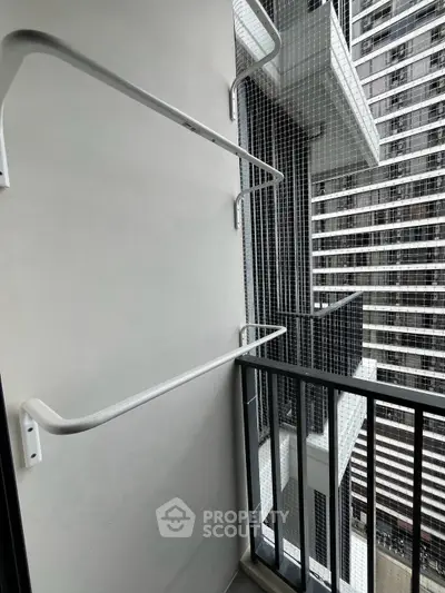 Modern balcony with sleek railing and urban high-rise view, perfect for city living enthusiasts.