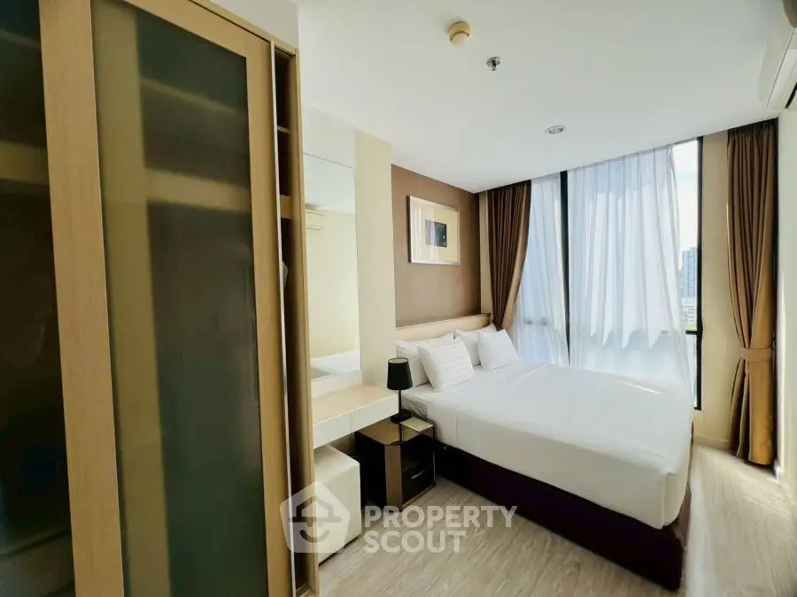 Modern bedroom with large window and stylish decor