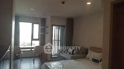 Modern studio apartment with cozy living area and natural light