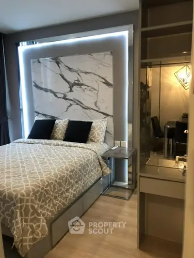 Modern bedroom with stylish marble headboard and elegant decor in a contemporary apartment.