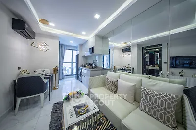 Modern open-layout living room with stylish decor and kitchen area